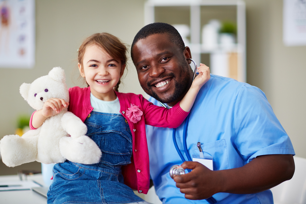 nurse with a child holding a stuffed animal