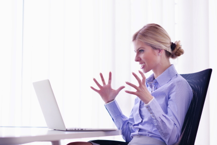 A lady screaming at a computer screen