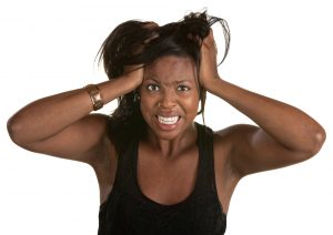 Stressed out African American Woman Pulling on her hair.