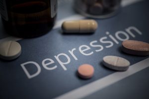 table with the words Depression written on it and different supplements tablets laying on the table