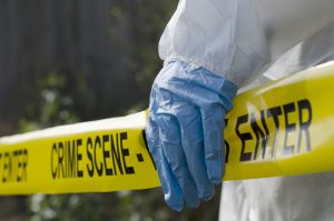 Picture of Crime Scene Tape with a Forensic Nurse.