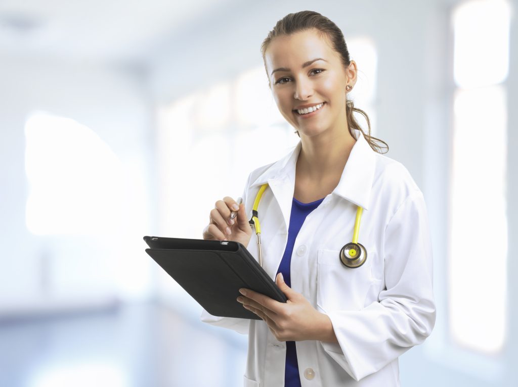 Female Doctor Standing At The Hospital With A Digital Tablet