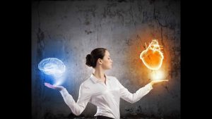 Meditation Instructor holding a blue globe in one hand and a flaming globe in the other hand.
