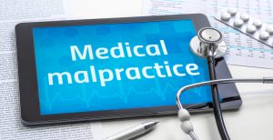 The word Medical malpractice on the display of a tablet