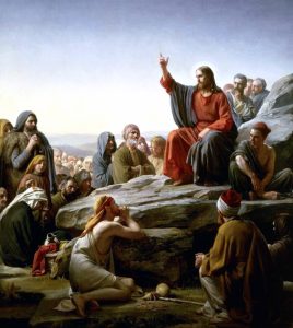 artwork of Jesus giving a sermon on a stone. 