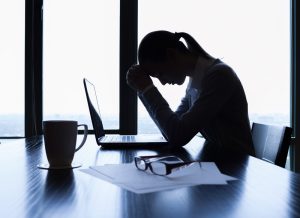 Woman stressed out by work taking a break at her laptop