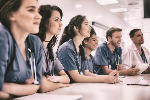 Nurses sitting in at a table. 