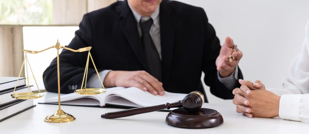 A lawyer and a doctor talk to one another. 