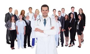 A group of hospital employees with a healthcare manager standing shoulder to shoulder. 