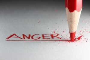 A red pencil drawing the word anger before breaking