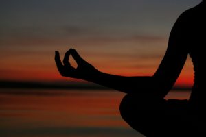 Picture of someone meditating at sunset