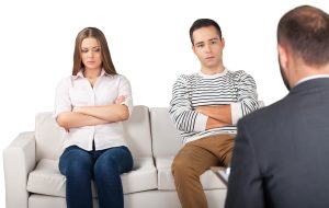 A young couple sitting during an anger management session.