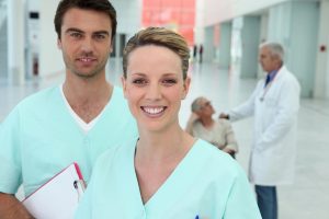 Two Health Care Ethics Consultants standing in a hospital hallway.