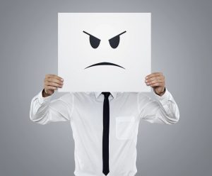 Anger Management Consulting! A picture of a man holding up an anger expression in front of his face.