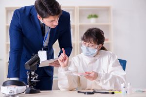 Two Forensic Nursing Specialists analyzing evidence. 