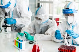 Forensic Nurses wearing PPE and working in a lab