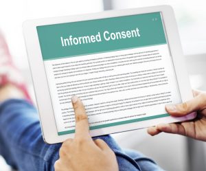 A notepad that says "Informed Consent" on it.