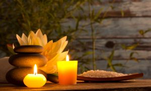 A picture of a spa with candles lit. 