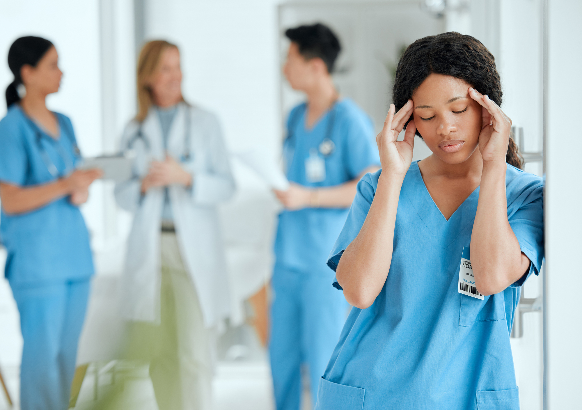 Headache, anxiety or sad surgeon in meeting with doctors with burnout, stress or fatigue with medical emergency. Migraine, tired black woman or depressed nurse with depression or loss in hospital.