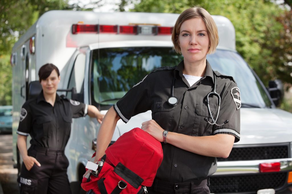 An paramedic standing in front of am ambulance 