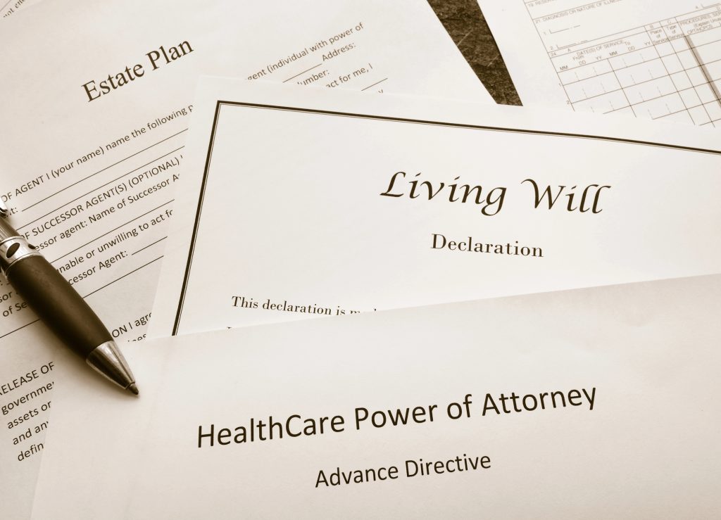 healthcare power of attorney advance directive papers with on a table with a pen near it
