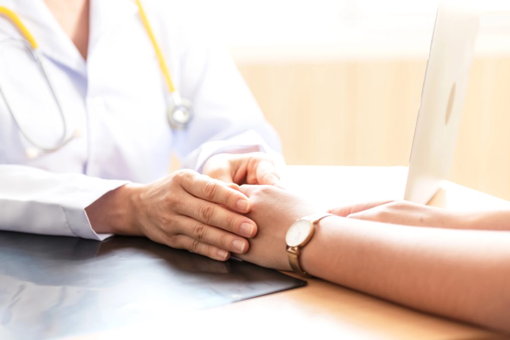 Doctor holding a patient's hand before an operation