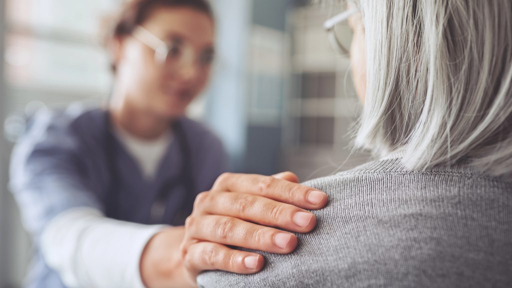 health care worker comforting a patient