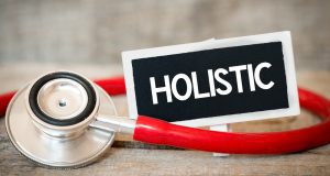 A small plastic sign that says "Holistic"