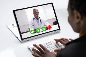 patient seeking a health care professional on their laptop via telehealth.