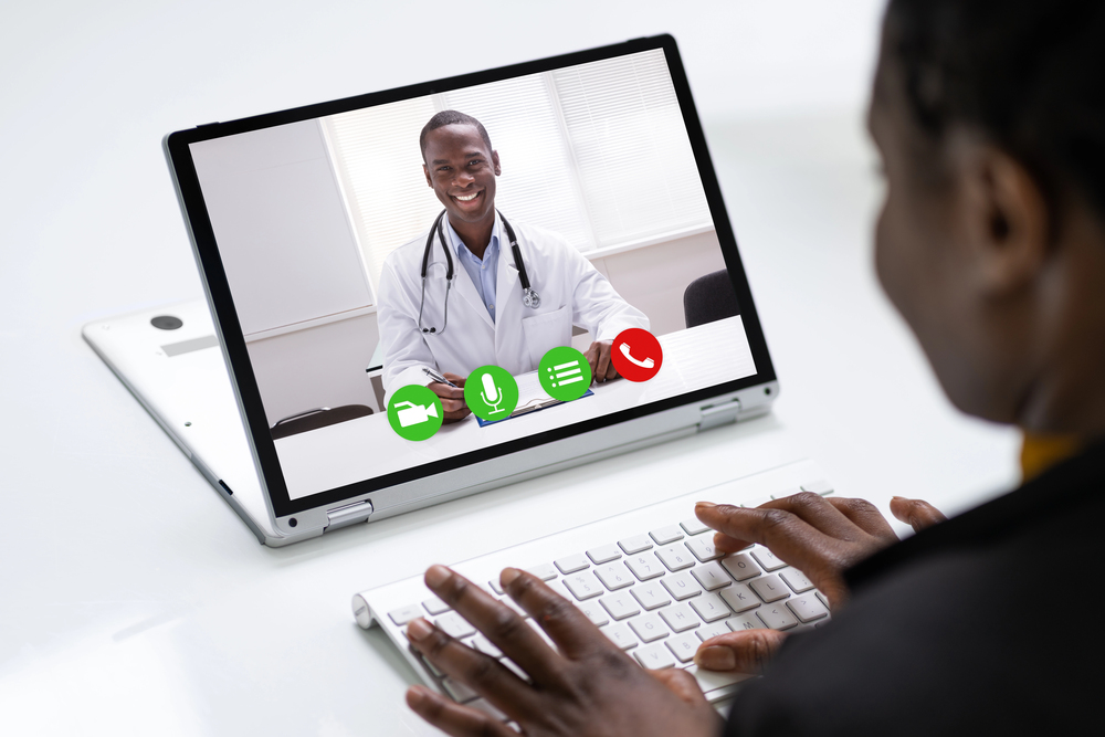 patient seeking a health care professional on their laptop via telehealth. 