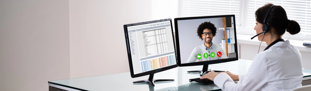 Nurse working on her computer using telehealth applications