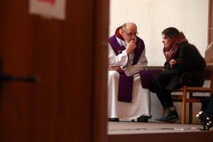A priest giving spiritual direction to a person in need