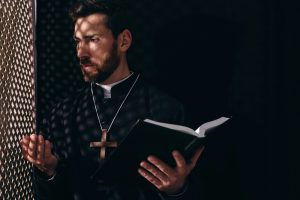 A priest giving spiritual direction during a confession
