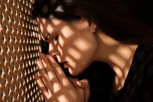 Woman in a confessional seeking spiritual direction