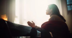A woman praying in a church