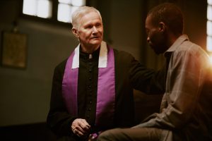 A priest giving spiritual direction to a man