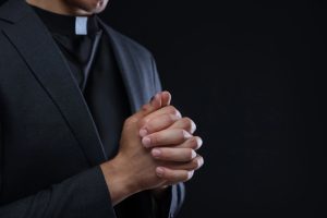Priest's hands held in prayer