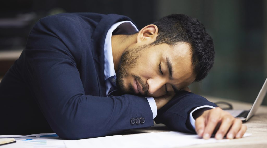 Man taking at nap at his desk