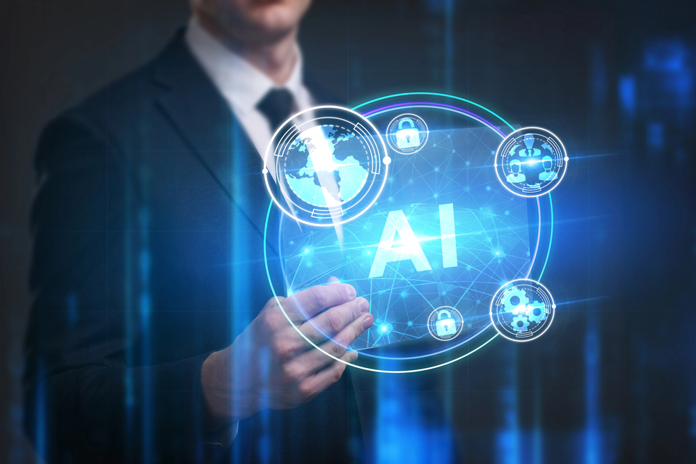 A man in a suite holding a hologram with the letters AI in it. 